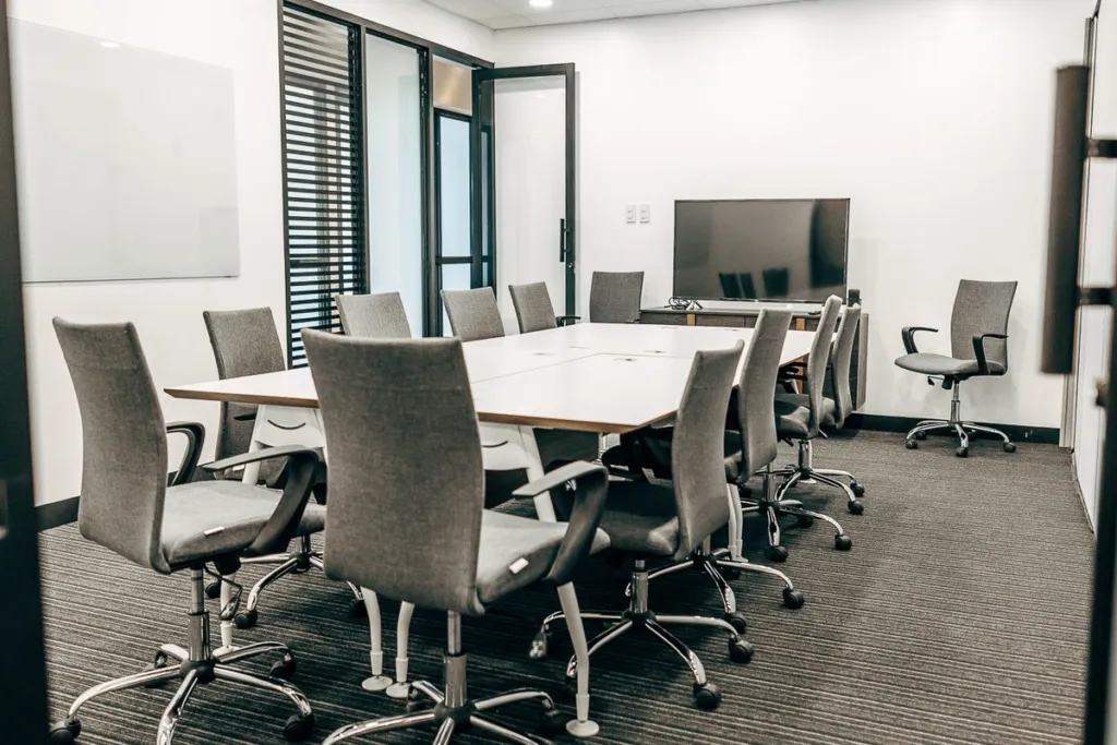 The Acceler8 Rockwell conference room with a screen and whiteboard
