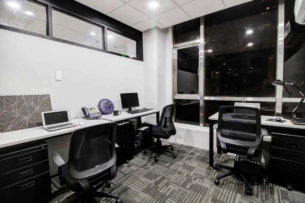 A serviced office show suite at Acceler8 Salcedo, desks and chairs beside the windows