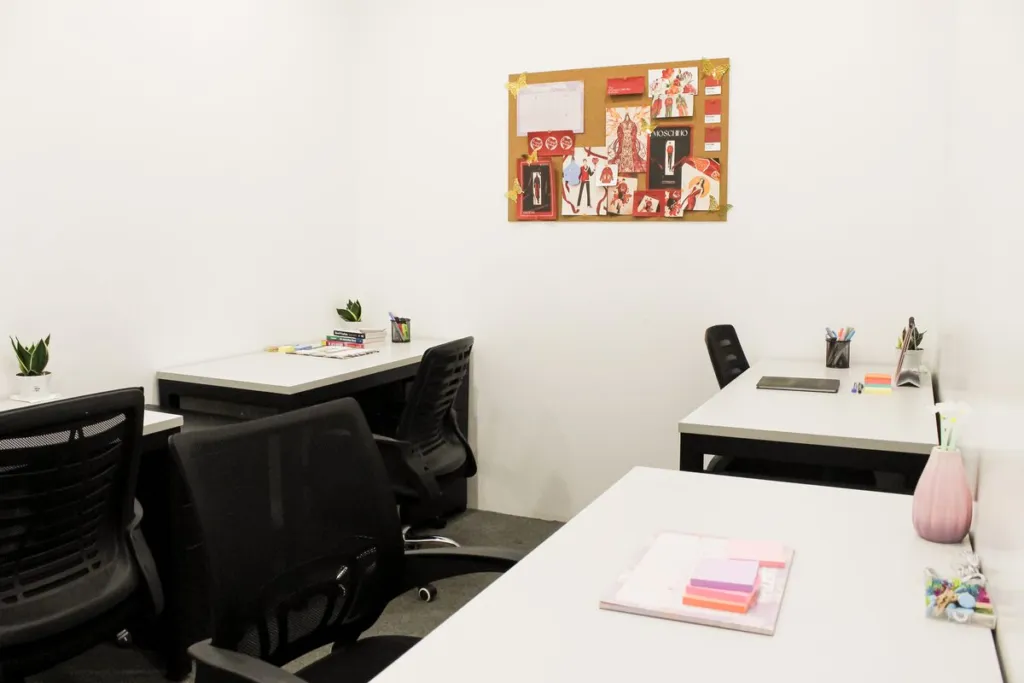A team's serviced office at Acceler8 Legazpi, desks, a pinboard and plants