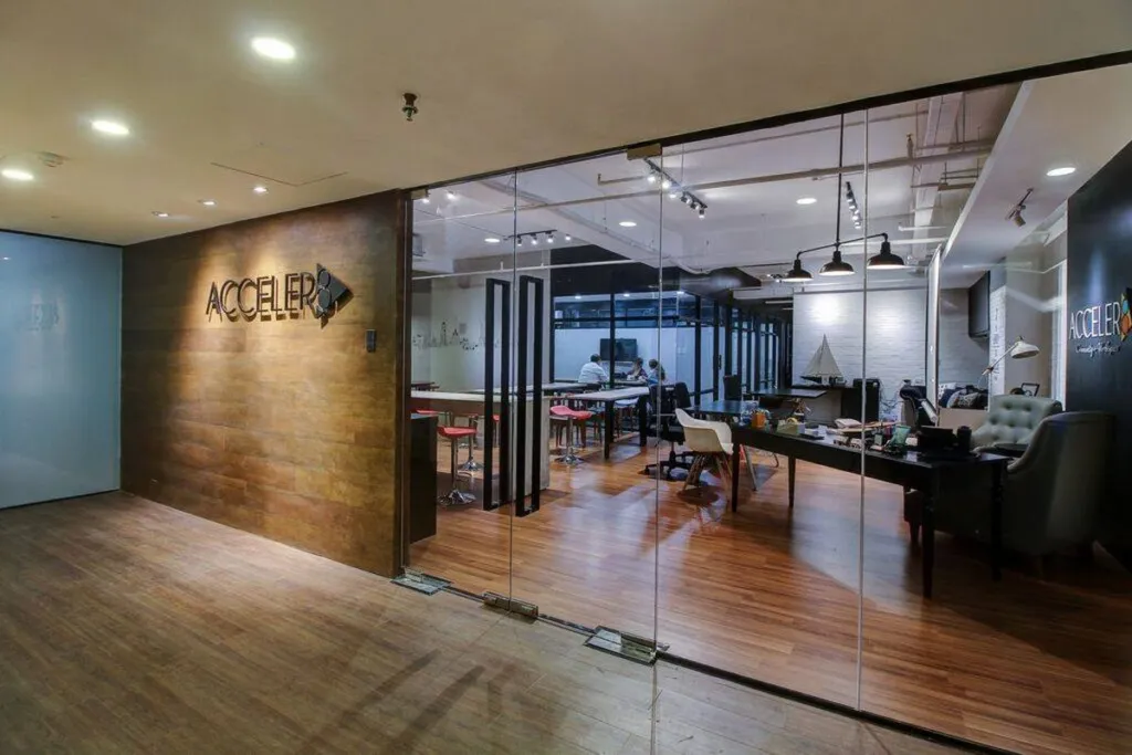The branded glass entrance to Acceler8, looking through to the work floor