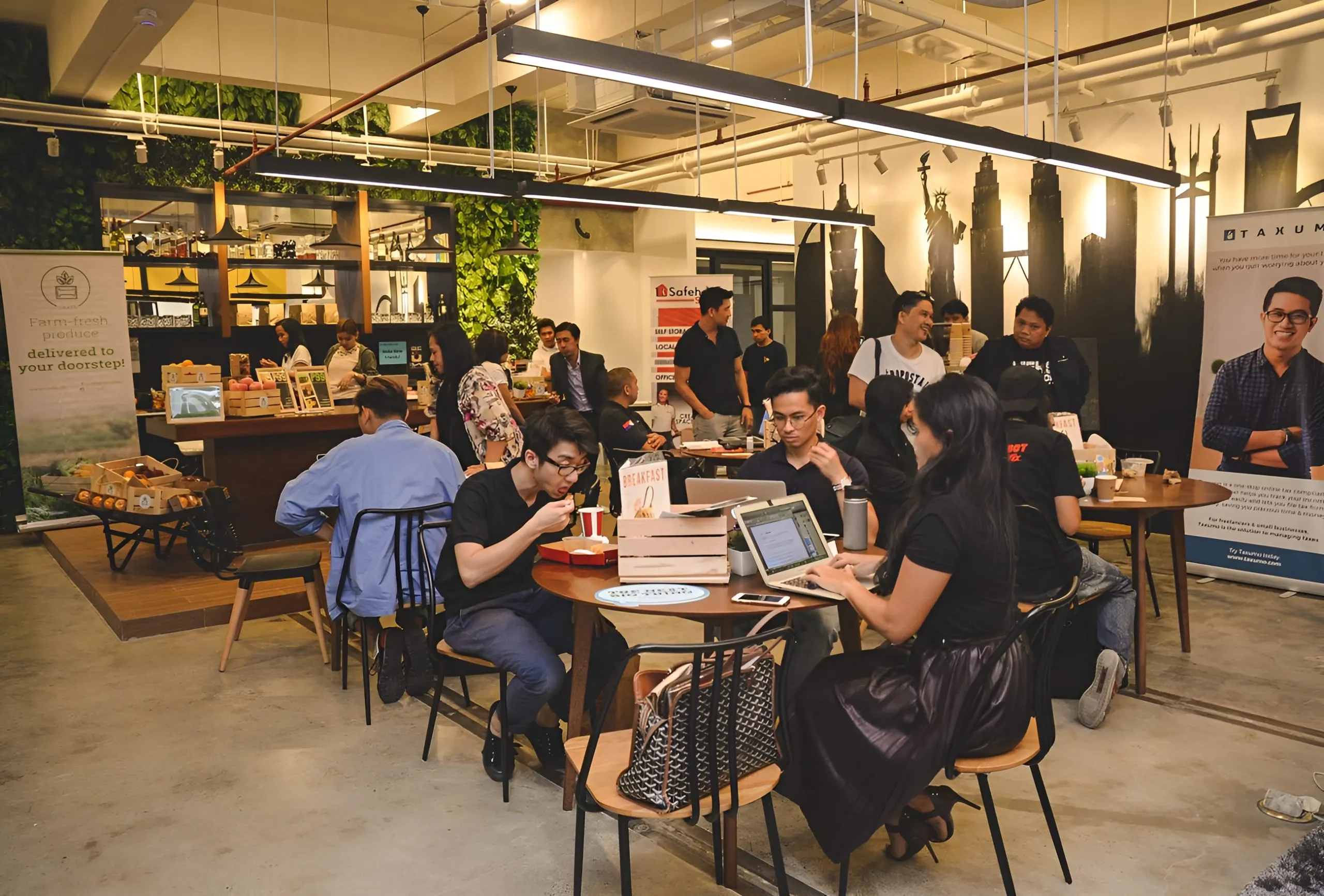 A workshop in progress at the Acceler8 event space, with attendees seated on the floor around a projector screen