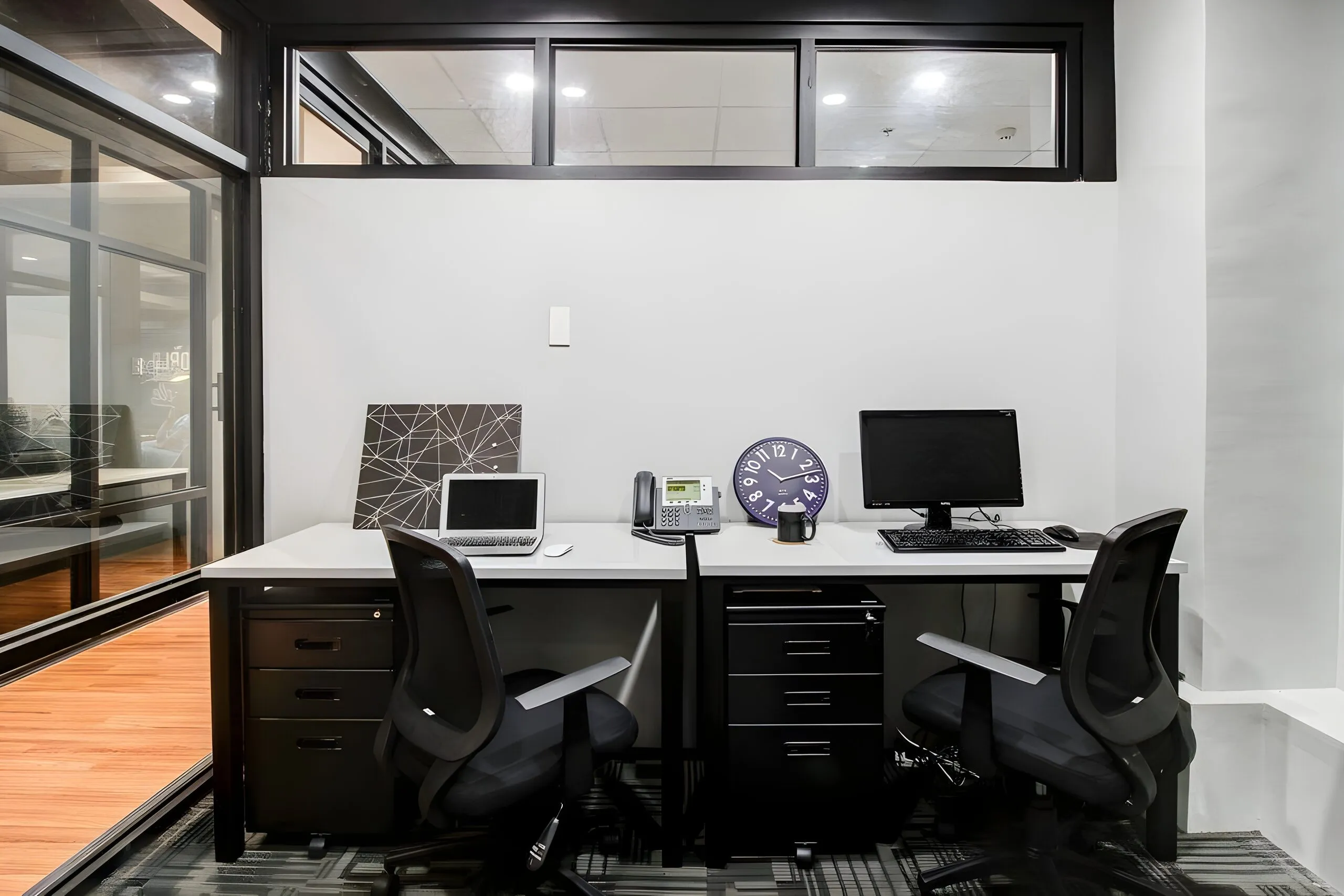 A private office at Acceler8 with two workstations, mobile pedestals and office chairs