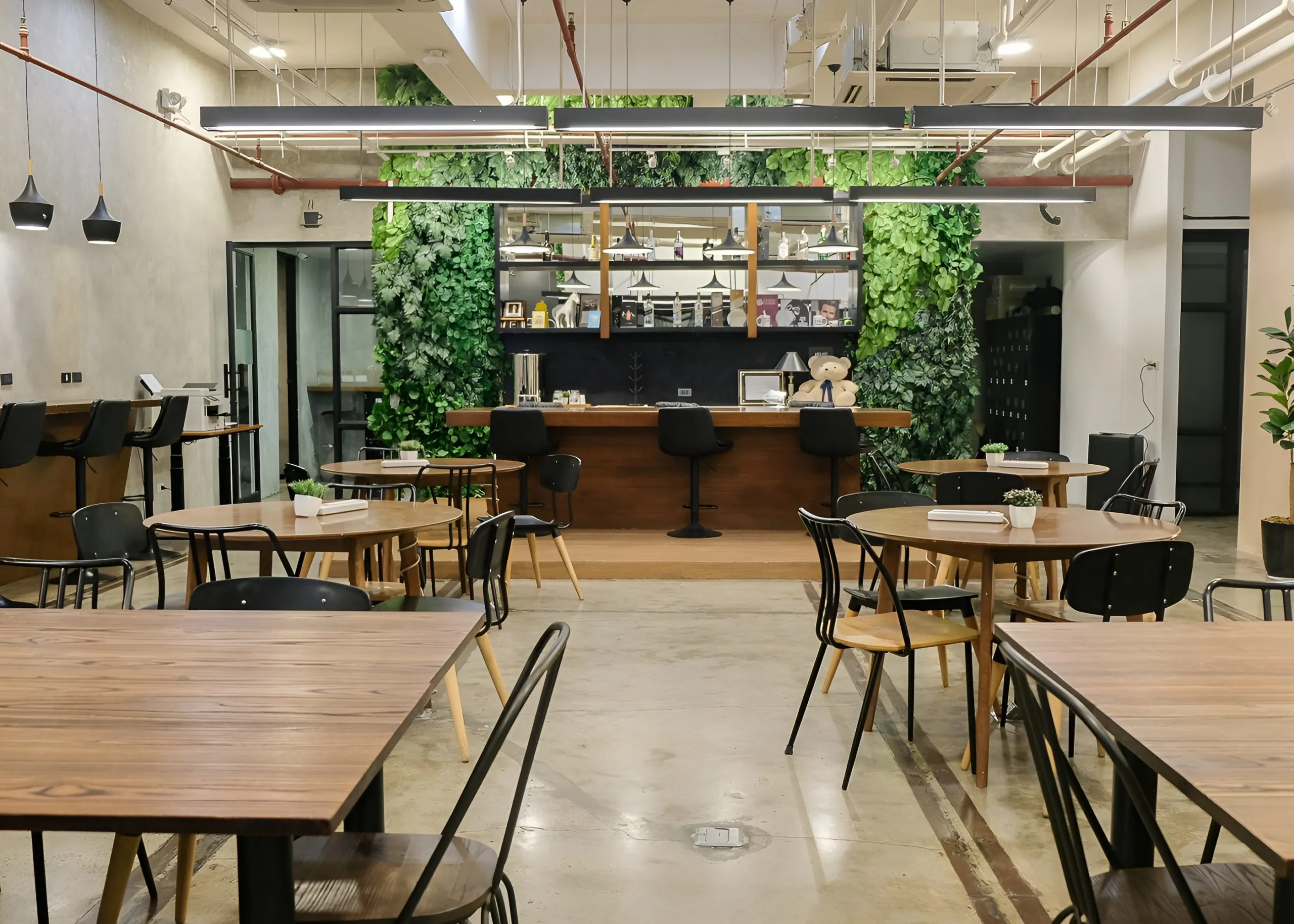 A community panel event at the Acceler8 Legazpi bar table, under pendant lighting and a living green wall