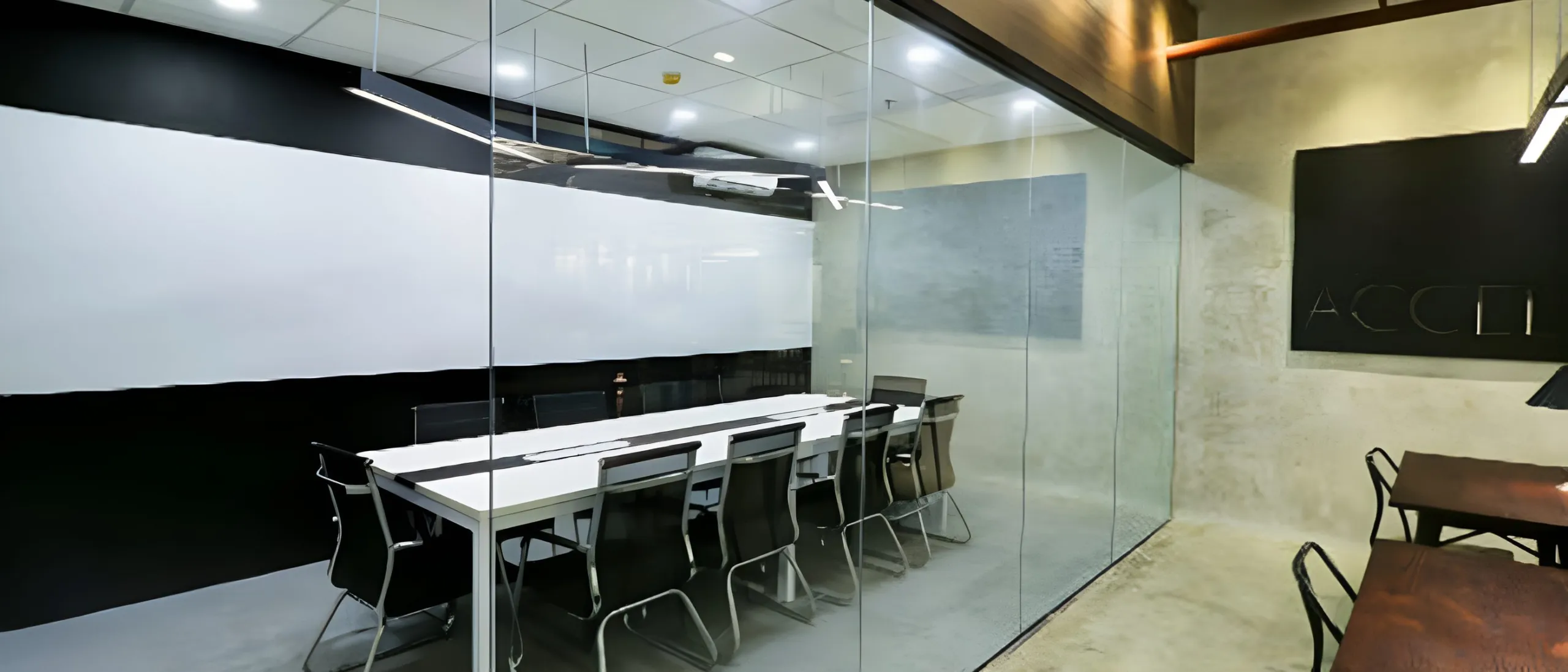 The glass-walled conference room at Acceler8 Legazpi, seating twenty