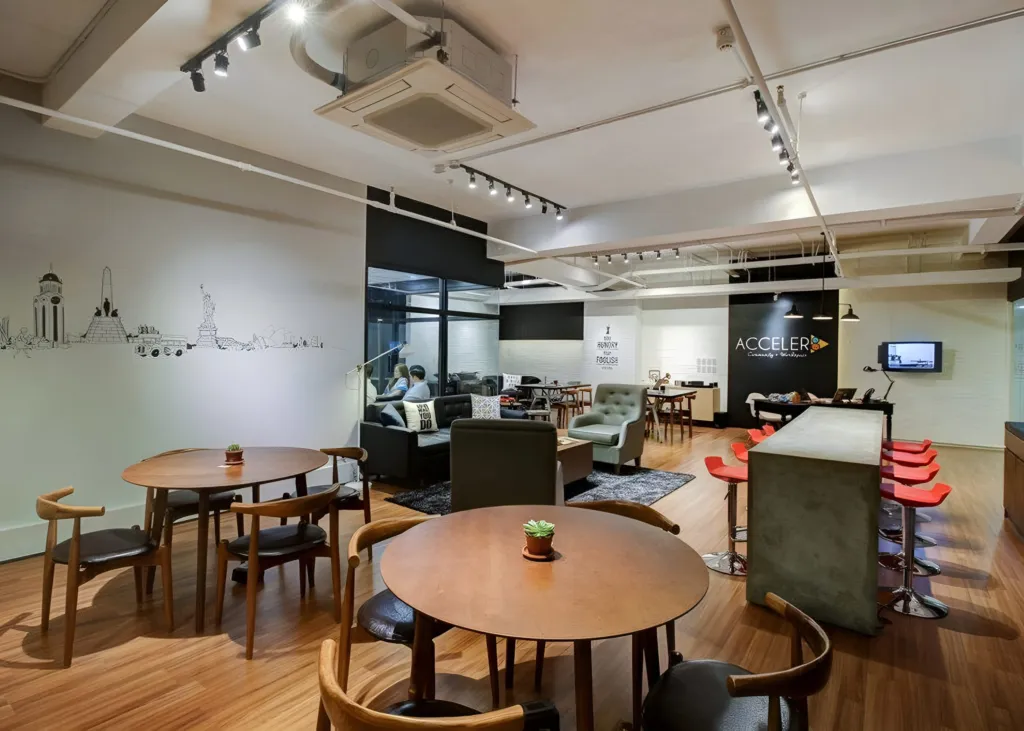 The Acceler8 Salcedo lounge with the branded wall, coffee bar and soft seating